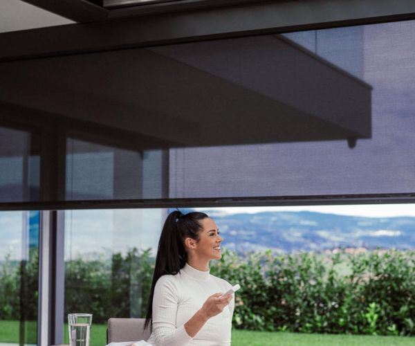 Bioklimatska pergola Misteral na terasi, ki se popolnoma prilega okolju, z možnostjo prilagajanja svetlobe in temperature.